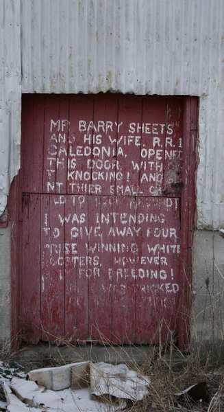 message on the barn door of the abandoned Lee house